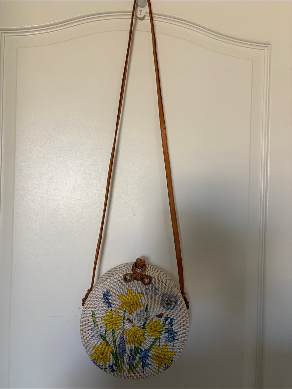 Round Straw Crossbody Bag with Yellow Floral Embroidery. 8x8 in., 24in strap